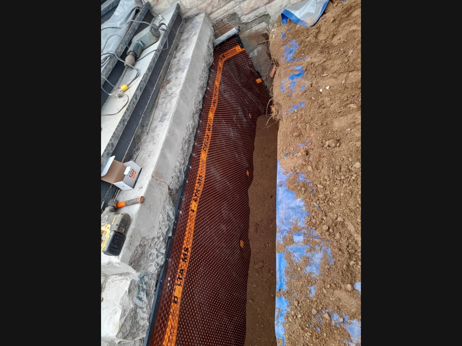 Interior corner drain installation on a Port Carling-area foundation